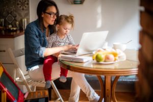 Mother with daughter working from home
