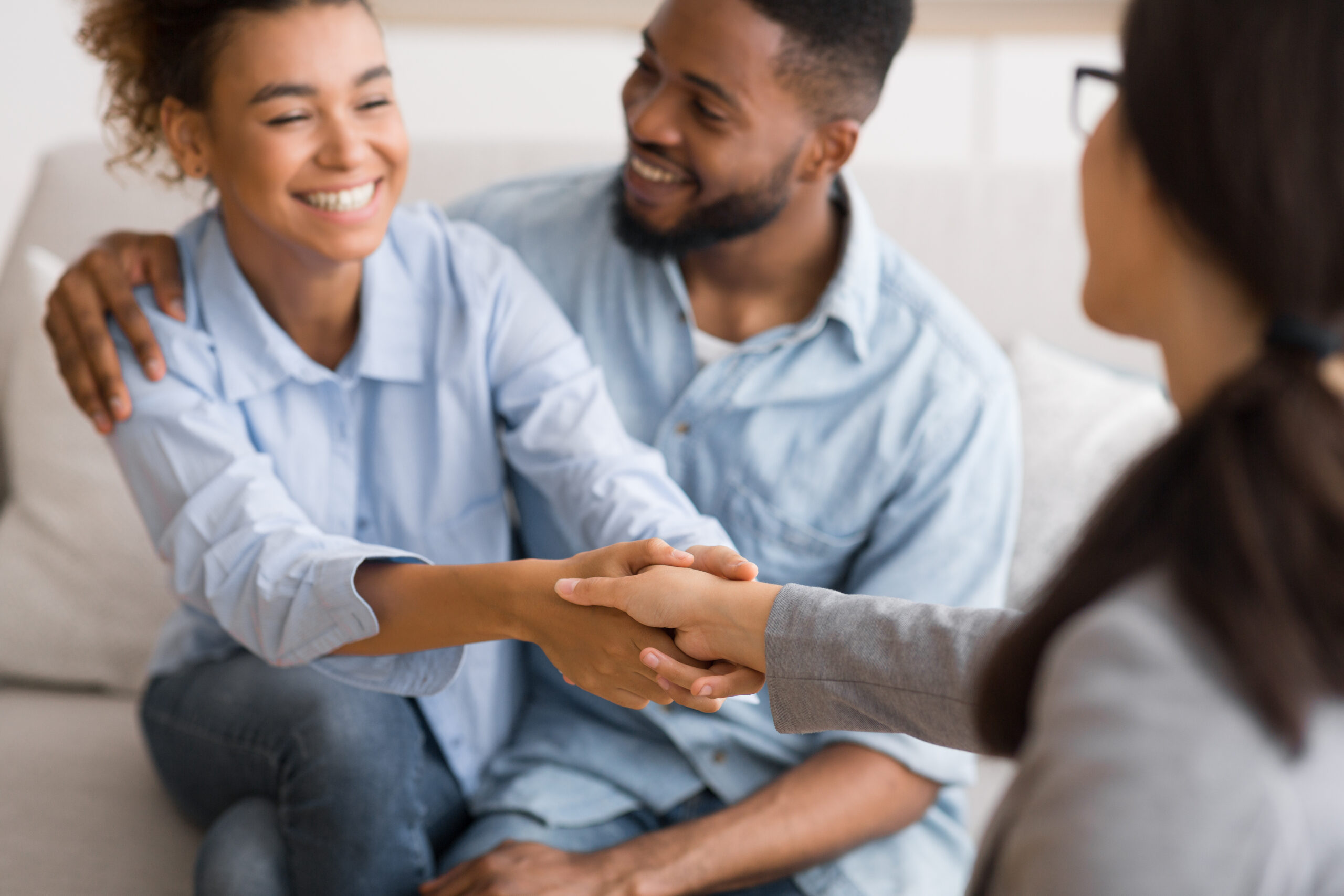 Health Sense Happy couple shaking hands with therapist after a successful session