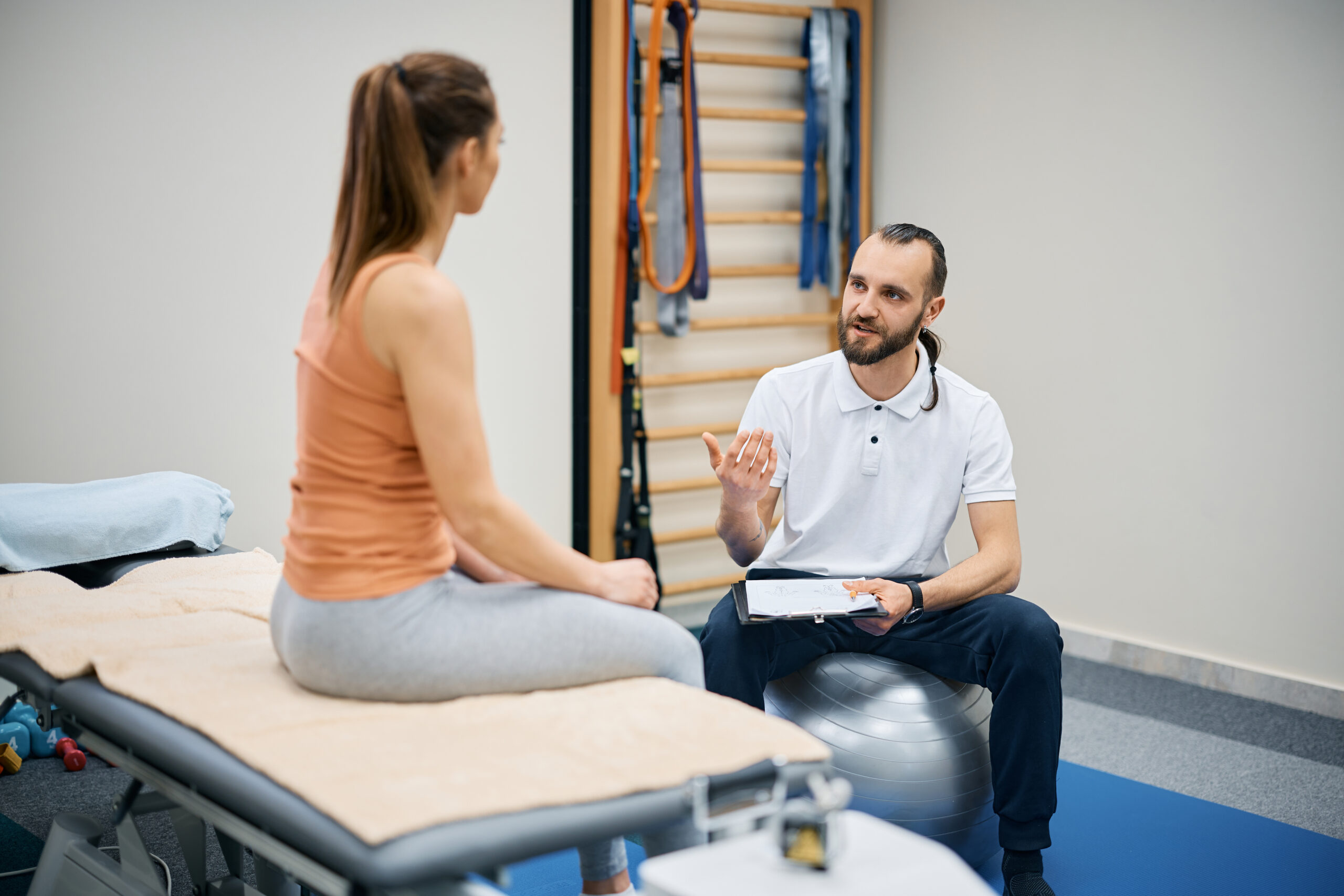 Health Sense Sports therapist talking with woman about mental skills training