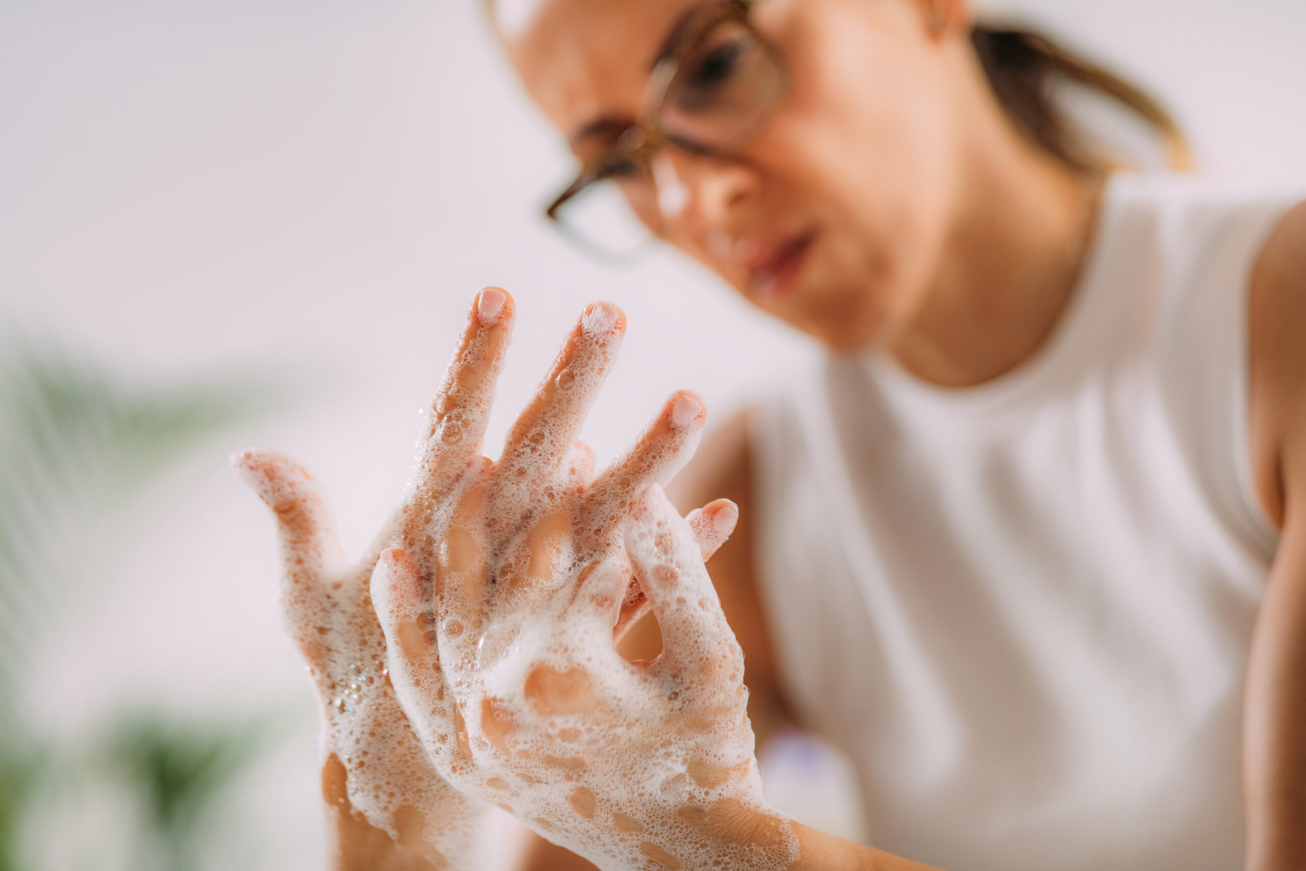 Woman struggling with OCD washing her hands