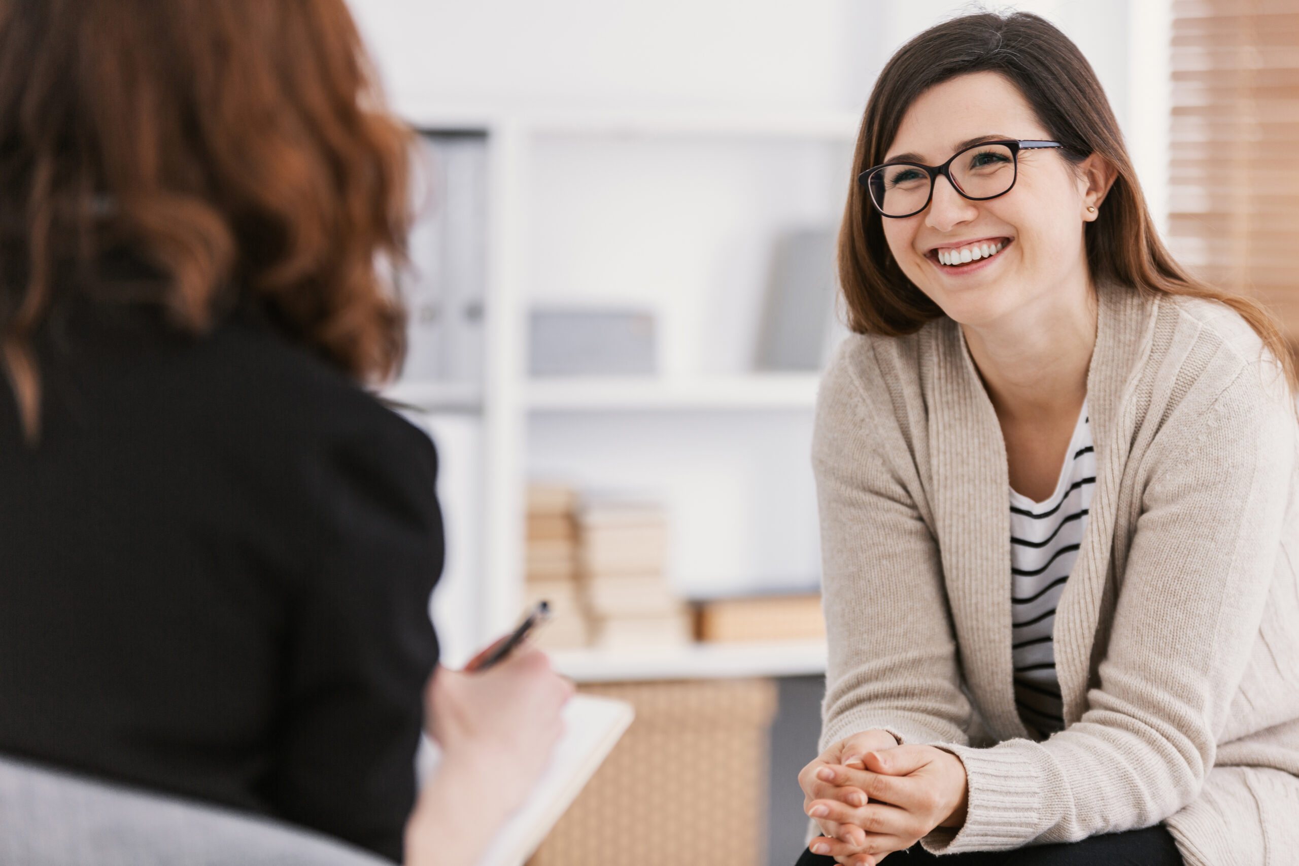 Woman patient smiling while practicing growth oriented psychotherapy