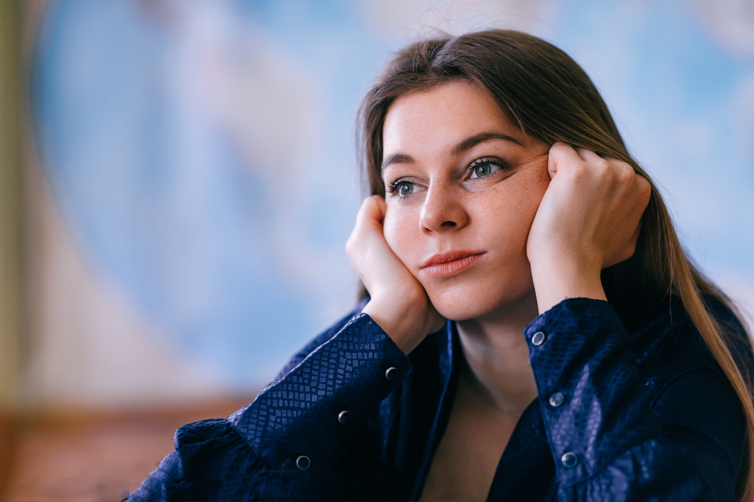 Young girl staring off into distance looking unmotivated