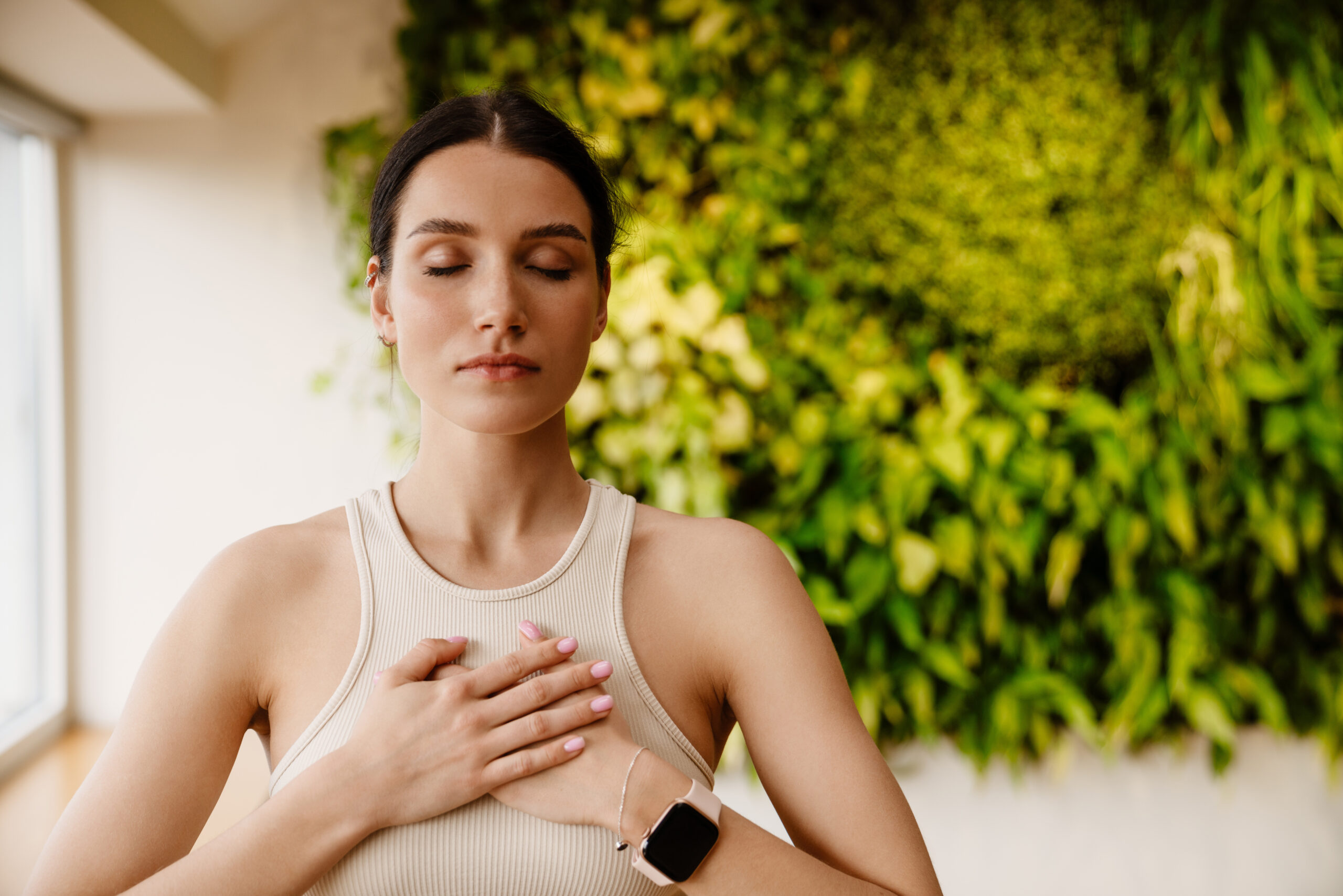 Young woman using breathing practices to cope with her stress and anxiety