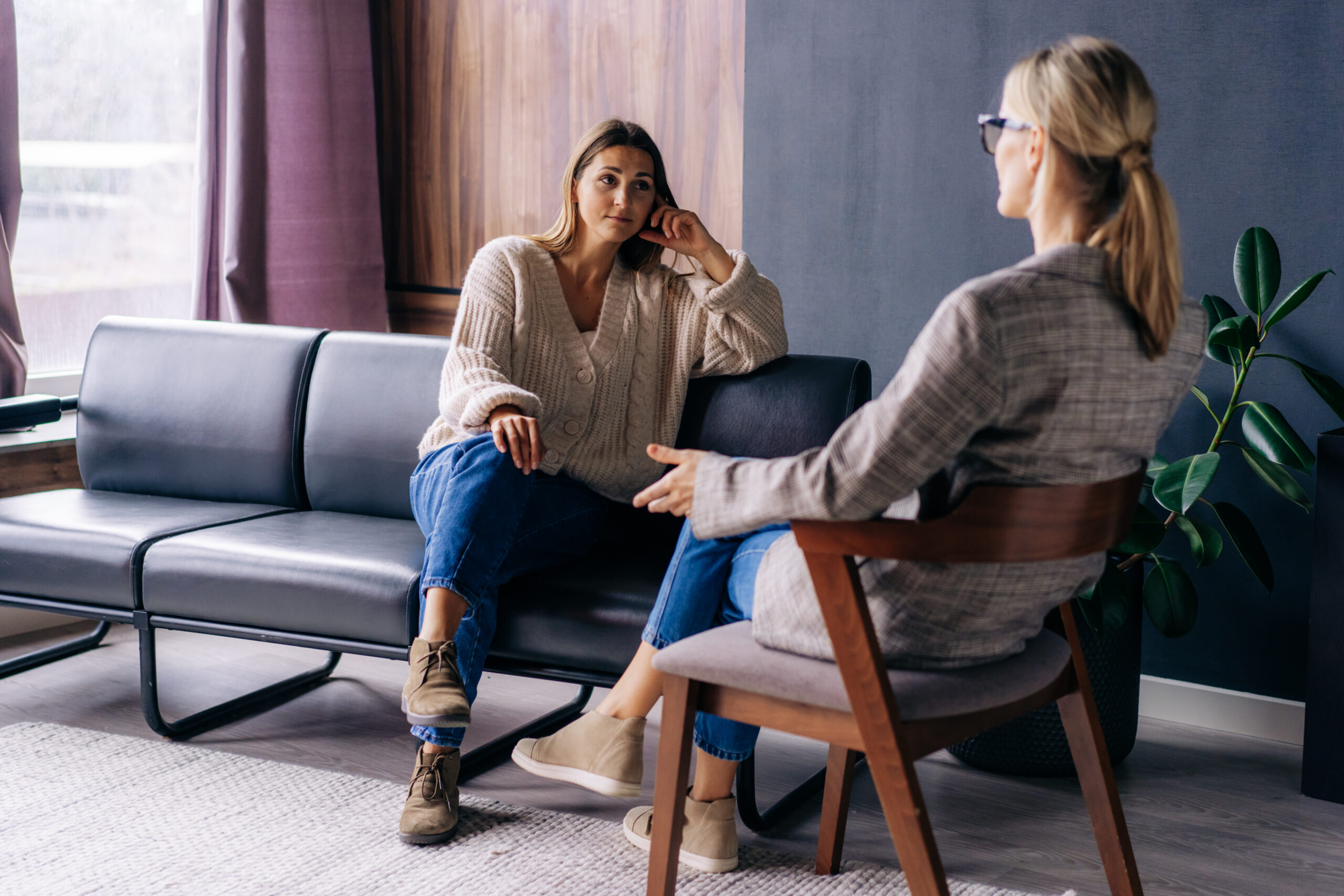 Young woman in an engaged conversation with her therapist
