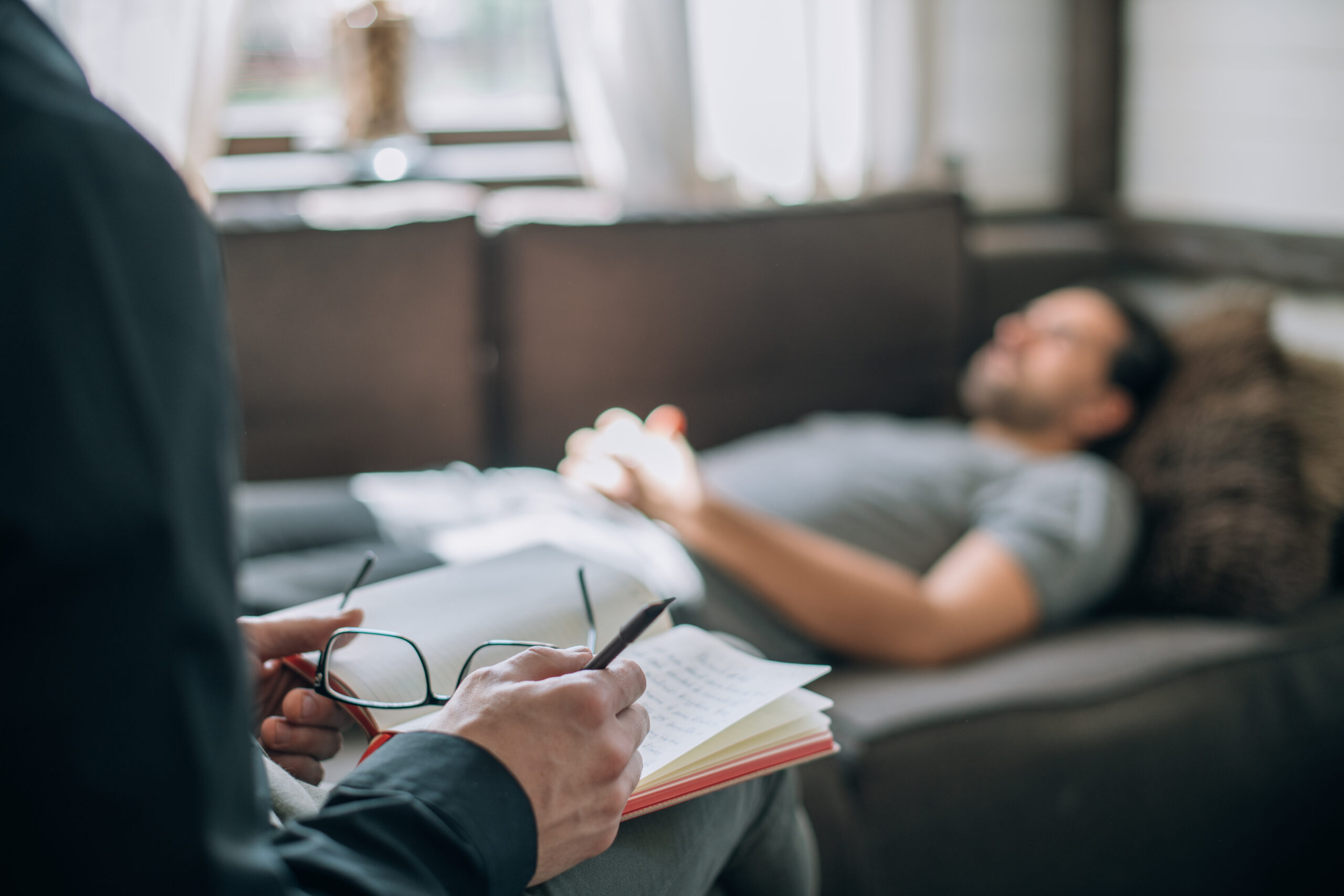 Male with emotional trauma on couch in therapy