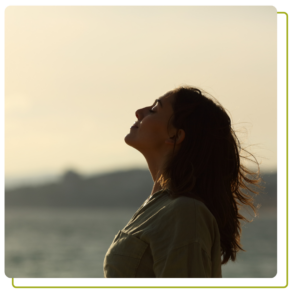 woman silhouette breathing fresh air on the beach