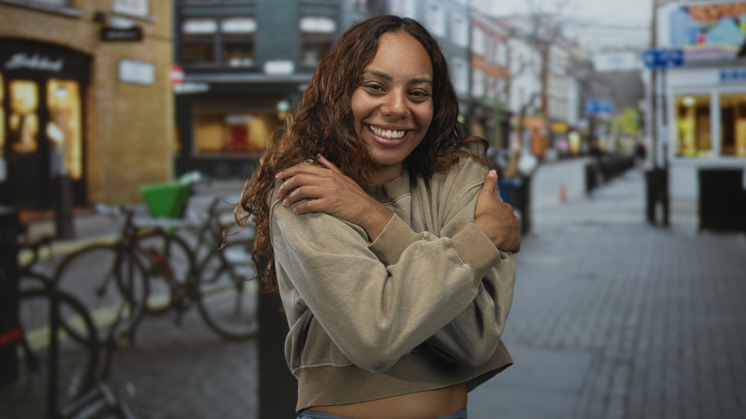 girl hugging herself socail image showing self kindness and emotional well being