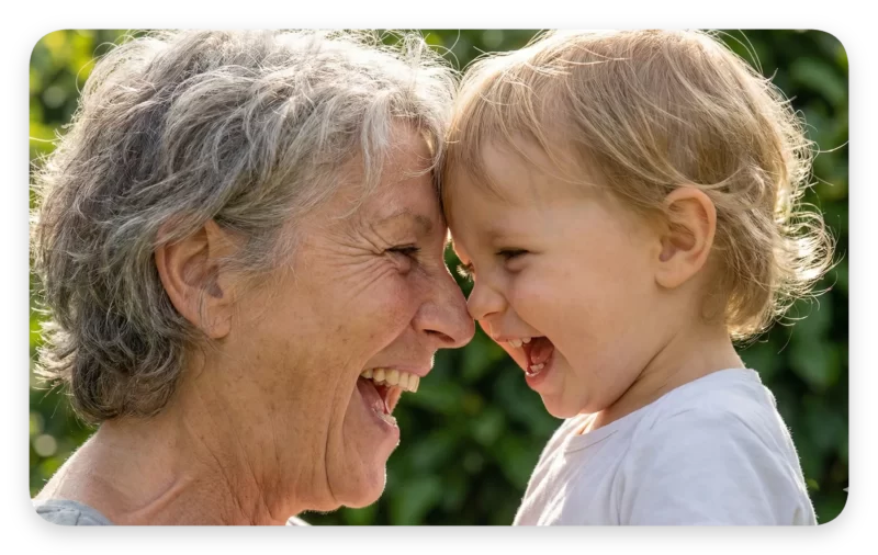 Smiling grandmother and grandchild touching foreheads, sharing laughter, embodying the connection central to interpersonal neurobiology.