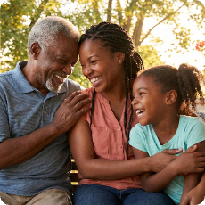 Three generations of a happy Black family: grandfather, mother, daughter, laughing. Shows strong family bonds promoting positive black mental health.