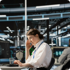 Woman standing in a data center looking overwhelmed, symbolizing AI anxiety and fear of job displacement in the modern workplace