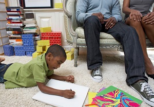 father and daughter with man seated in background observing