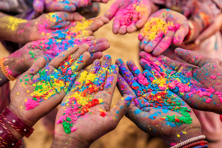 Children's hands covered with colorful dust during festival of Holi