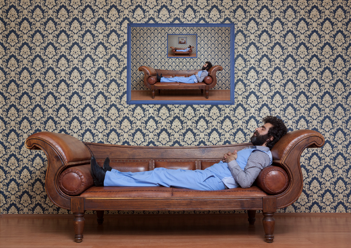 Man hypnotized on couch with multiple reflections