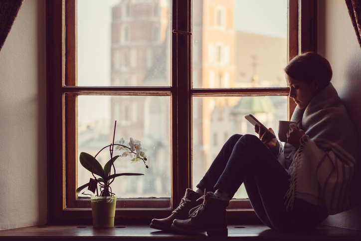 Person sitting in window looks up symptoms