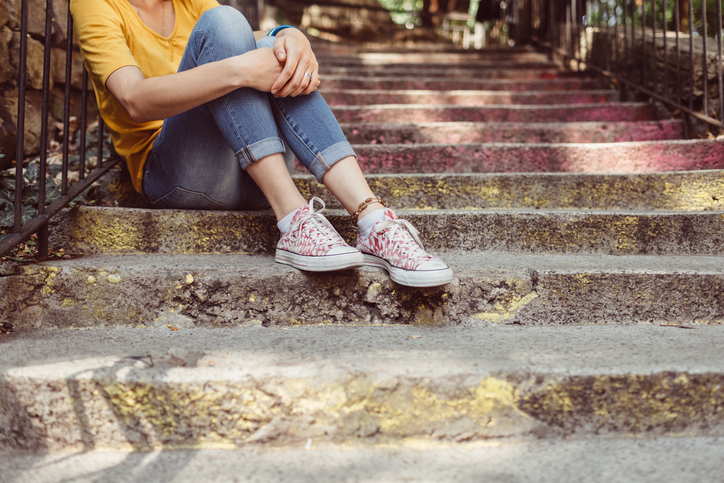Girl sitting on cement steps