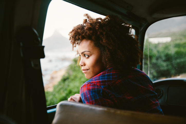 Woman thoughtfully looking out car window