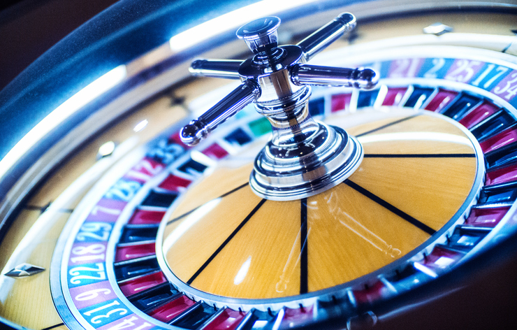 A tilted image of a polished roulette wheel.