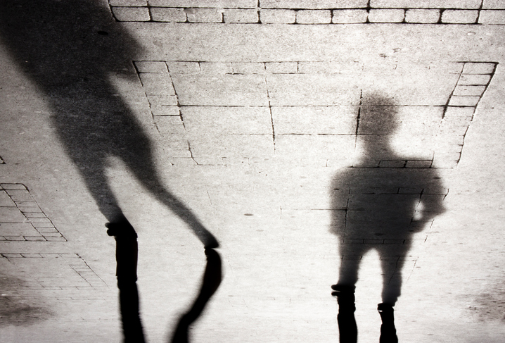 Upside down shot of intimidating shadows on cobblestone.