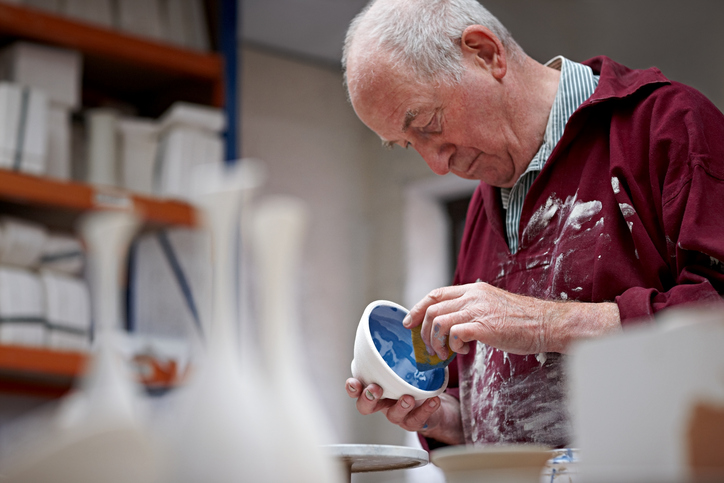 A senior man takes time to engage in his pottery hobby.