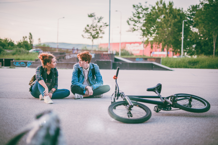 Siblings take a break from their bike ride to have a serious talk.