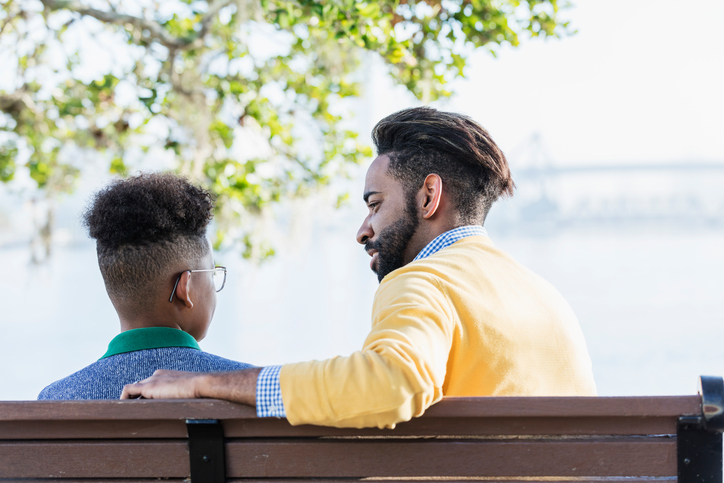 A concerned father has a private talk with his son.