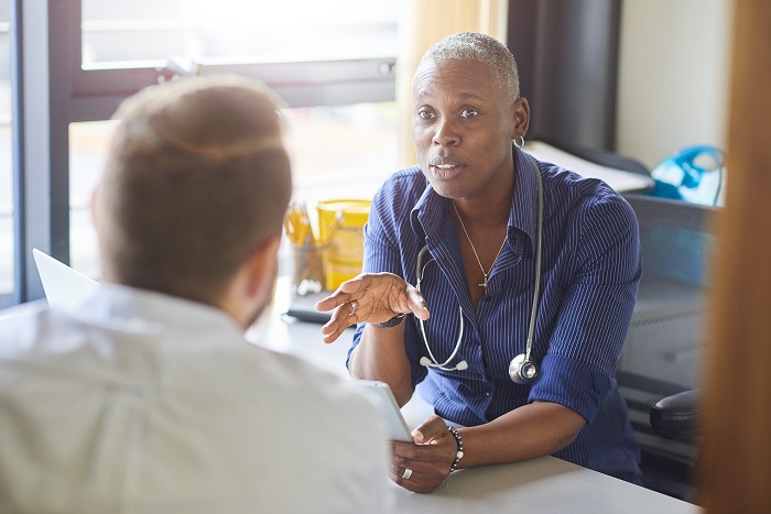 Man talking to a doctor in a peaceful, naturally lit office.