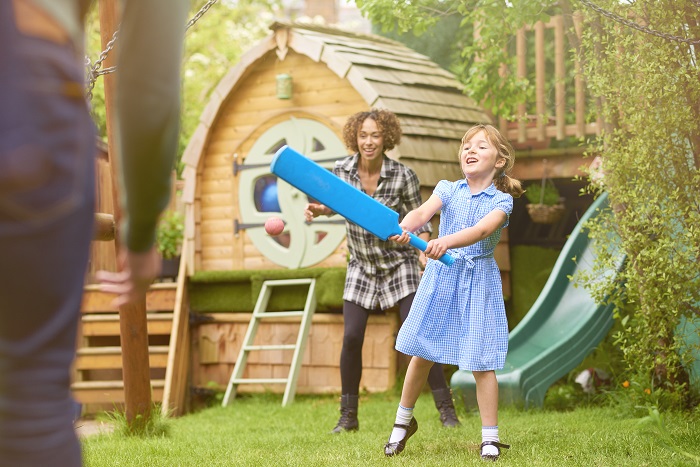 Girl playing game outside with her adoptive family