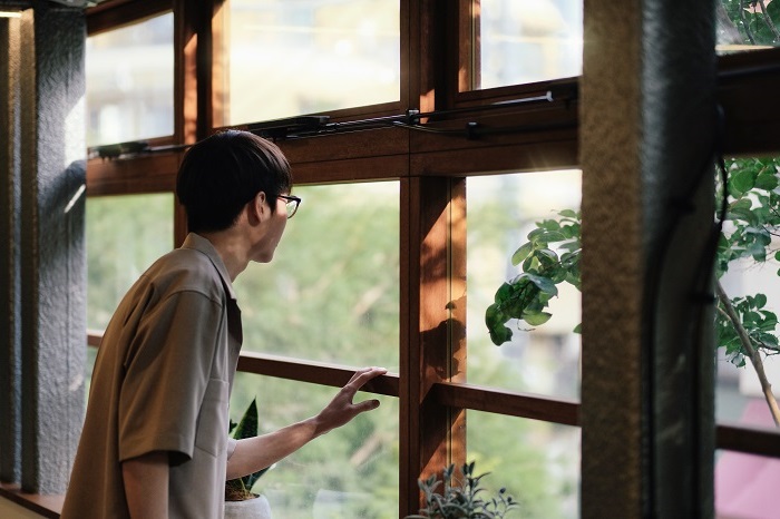 Young man looking out of a window