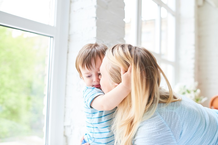 Toddler hugging his mother