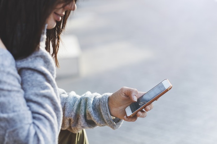 Woman secretly reading a text