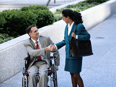 Two therapists shake hands on the way to a conference.