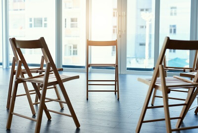 Three wooden chairs in a circle