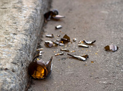 Broken beer bottle on the side of the road