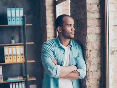 A man with C-PTSD looks out a window.