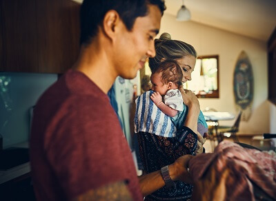 New parents in the kitchen with their baby