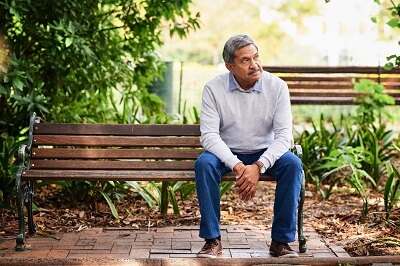 Man sitting on a bench, doubting himself