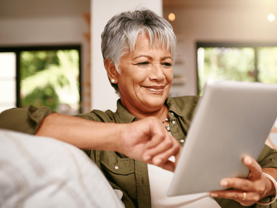 A therapist uses a tablet to explore her social media profiles.