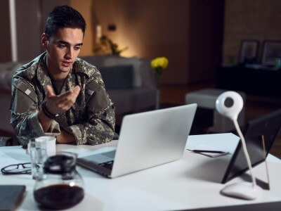 A young veteran talks to a therapist through video chat.