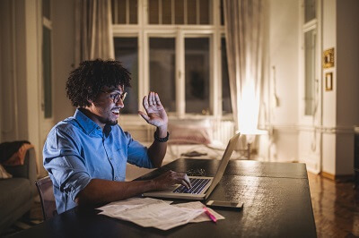 Man speaking with a therapist online from his home