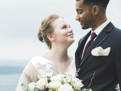 A bride and groom smile at each other