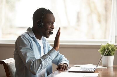 Therapist waving to online therapy clients.