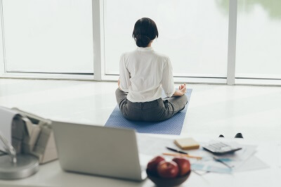 Professional meditating away from their desk