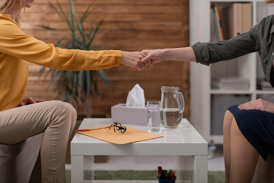 Therapist and client shaking hands