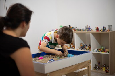 Child in a sandplay therapy session