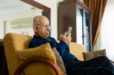 Senior man looking at his phone