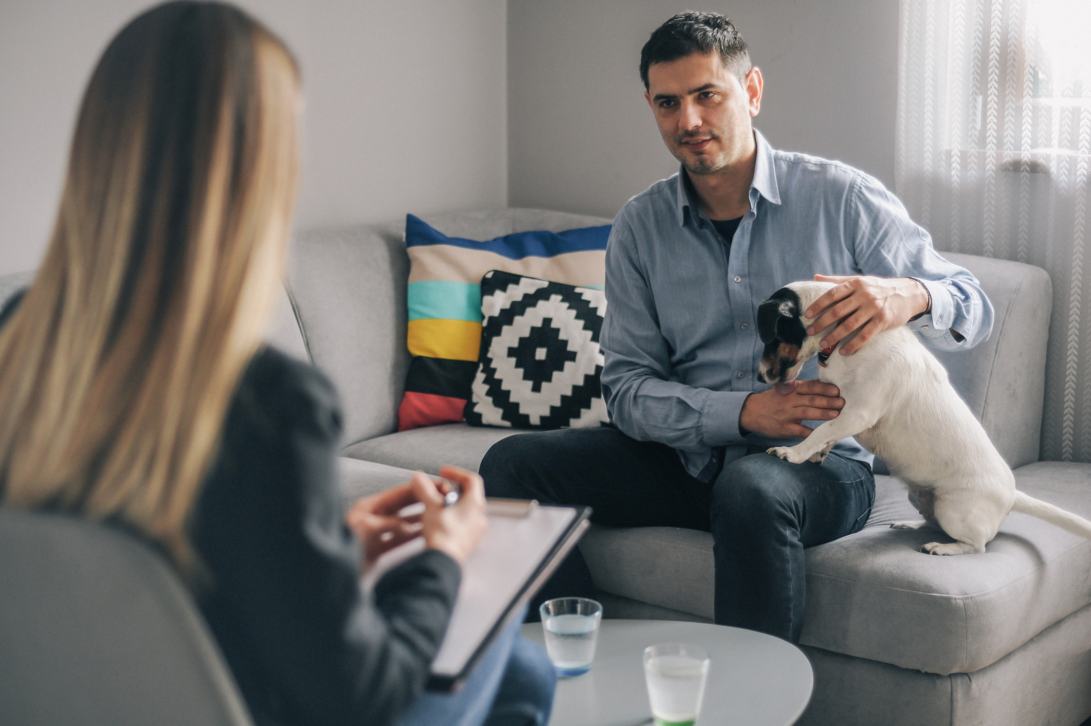 Man attending therapy with a therapy dog.