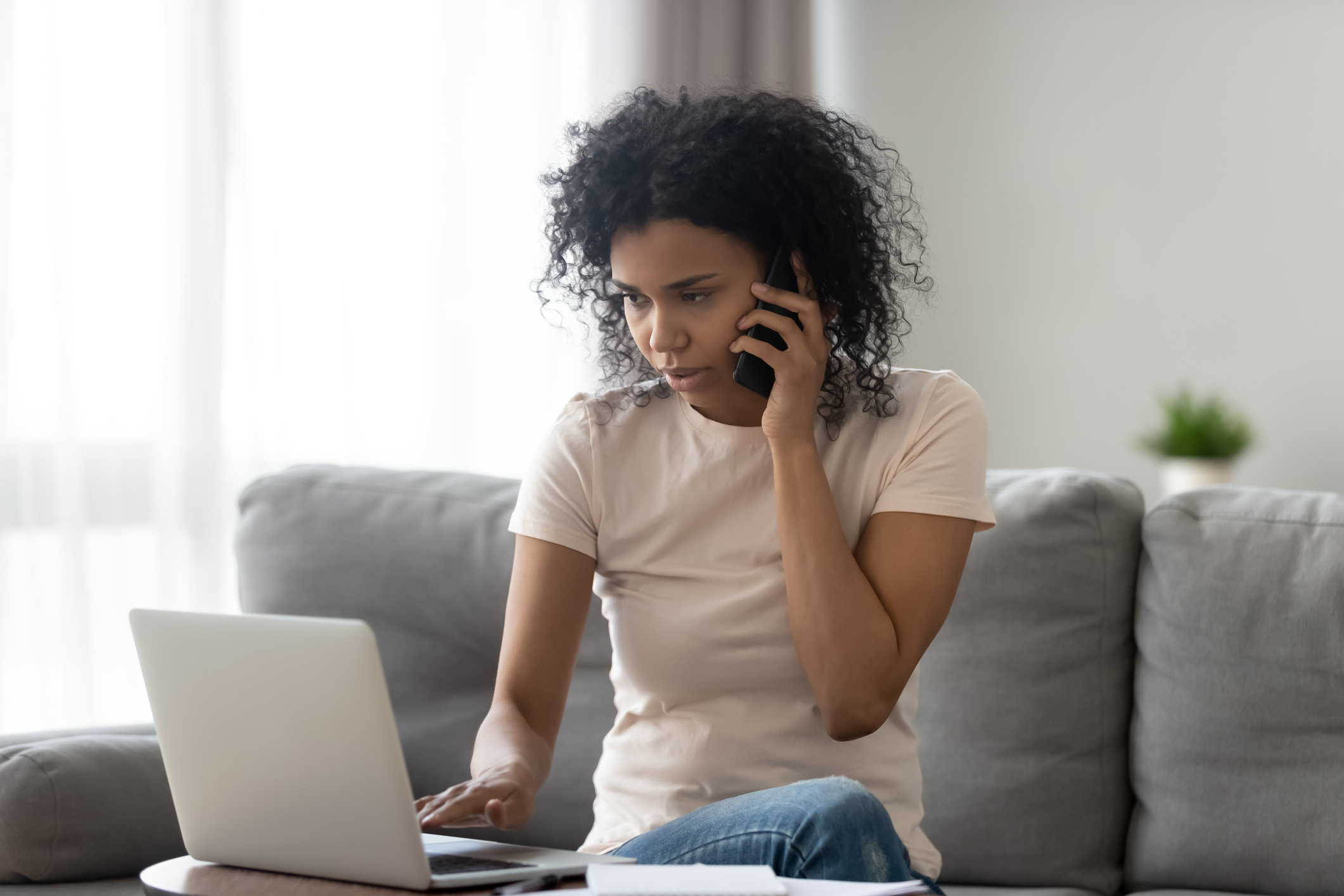 Young woman calling a therapist from the internet.