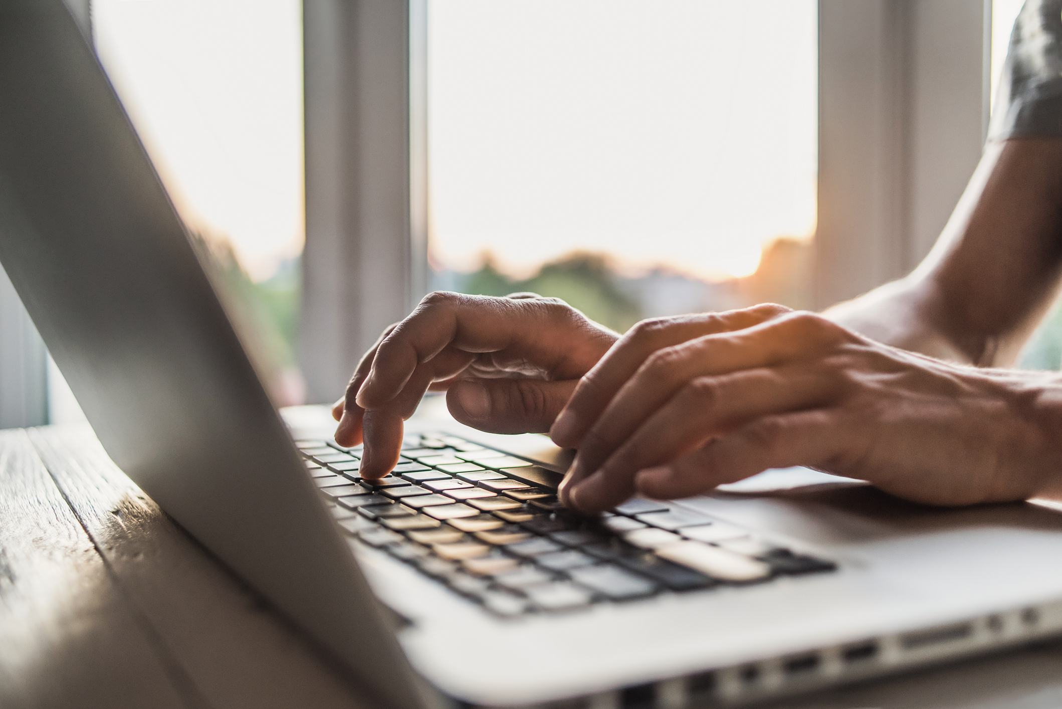 Therapist's hands typing on a laptop. 