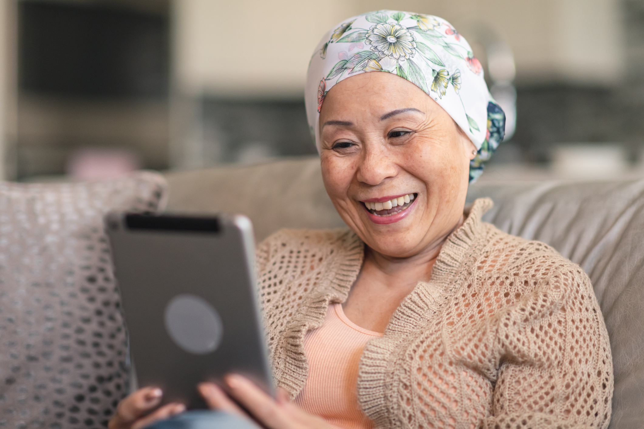 Older woman meeting with a therapist on a tablet.
