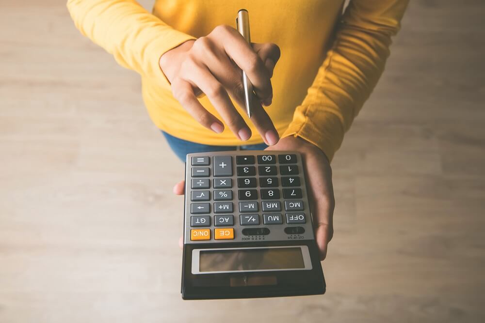 A therapist calculates session fees using a calculator.